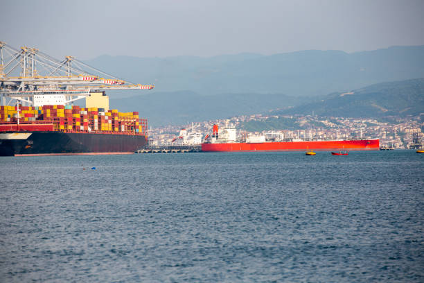 istock Cargo container ship loading on commercial dock in scenic view of industrial area 1403833457