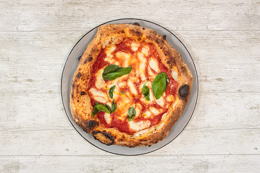 Italian handmade fresh pizza on wooden table high angle view