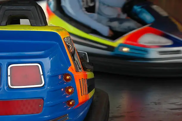 Bumpercar in fairground on collision course with other car.