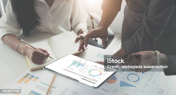 Teamwork With Business People Analysis Cost Graph On Desk At Meeting Room Stock Photo - Download Image Now