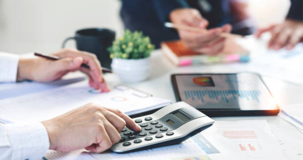 istock Businessman working at office with documents, calculating and analyzing the financial report, business plan investment, finance analysis concept. Using calculator. 1403838794