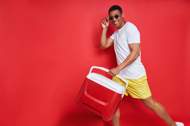 istock Happy mixed race man carrying cooler box 1403839119
