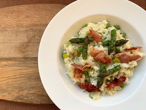 Risotto with asparagus and speck. Spring Italian dish. Directly above.