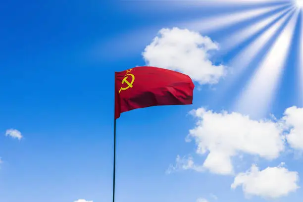 Photo of CCCP USSR Soviet Union flag waving in the blue cloudy sky