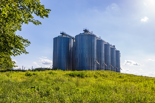 Agricultural silos granary tower. Large iron barrels of grain.