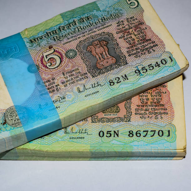 istock Old Five Rupee notes combined on the table, India money on the rotating table. Old Indian Currency notes on a rotating table, Indian Currency on the table 1403841491
