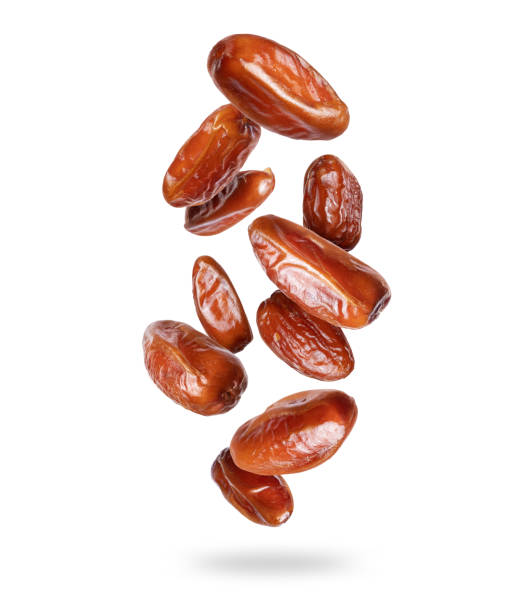 istock Delicious dried dates in the air closeup isolated on a white background 1403842393
