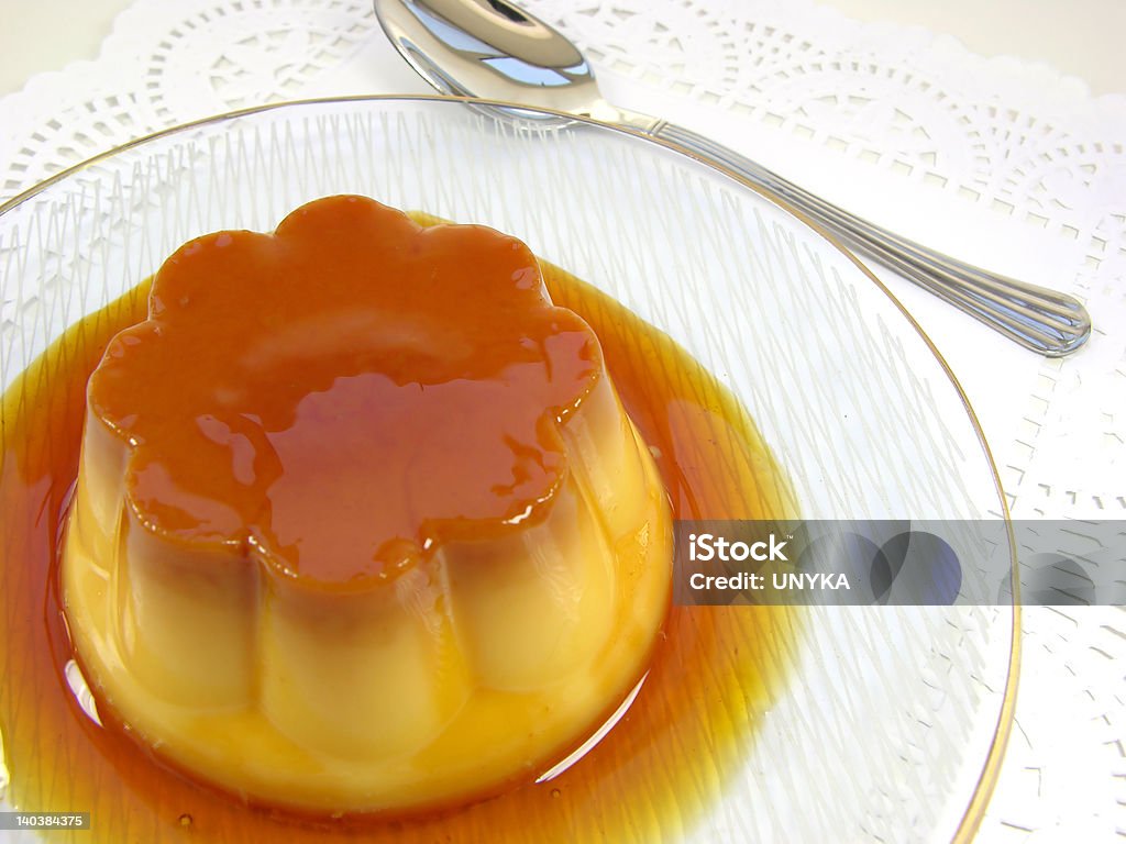 Single Vanilla Flan Upside Flan: Sweet custard with a caramel topping. Pudding. Vanilla flavour. CrAme caramel, known as ""flan"" in the US and Spanish speaking countries, and ""caramel custard"" in UK. It's a kind of rich custard dessert with a layer of soft caramel on top, where some caramel syrup is poured into the mold before adding the custard base. After the custard has set, it can be turned out, leaving a caramel sauce on top. Like all custards, flan is made with whole eggs, milk or cream, and sugar. Cake Stock Photo