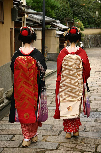 Maiko Two maiko women walking down the street of Kyoto, Japan. kimono photos stock pictures, royalty-free photos & images