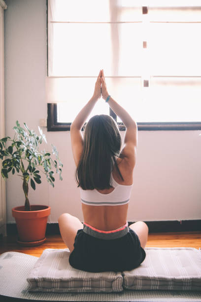 istock Young girl practicing yoga at home 1403845497