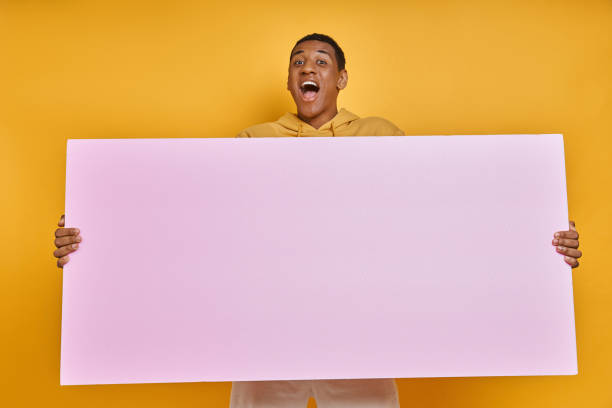 istock Excited mixed race man carrying blank banner 1403846722