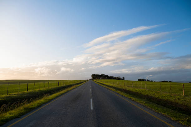 istock Tar road with clouds and blue skies 1403847072