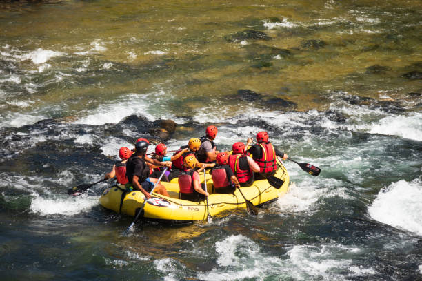 Valstagna (VI), Italy- June 19, 2022: A group of people enjoying white water rafting on the rapids of the Brenta River