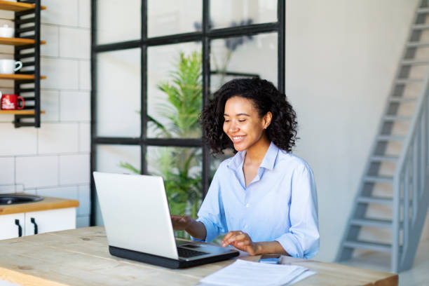 istock Young Black Woman Working From Home Using Laptop 1403849780
