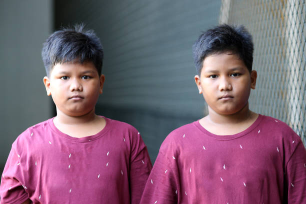 Young Burmese schoolboy with thanaka standing in the ancient temple of Bagan, Myanmar (Burma)