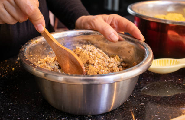 istock arabic woman hands while preparing walnut filling to make keto kahk for eid 1403850102