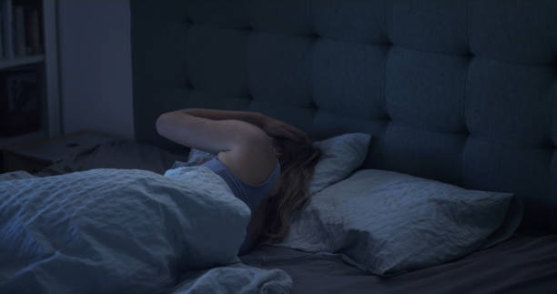 istock Woman in bed can't sleep due to insomnia 1403850274
