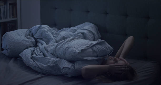 istock Woman in bed can't sleep due to insomnia 1403850294