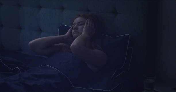 istock Woman in bed can't sleep due to insomnia 1403850320