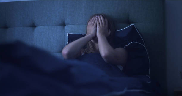 istock Woman in bed can't sleep due to insomnia 1403850345