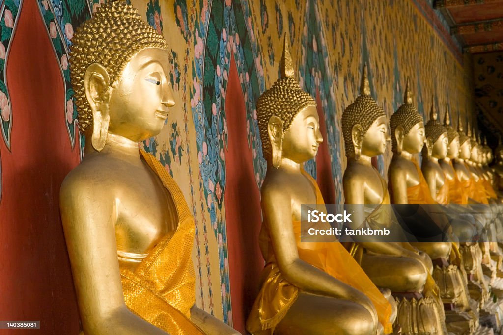 Gold Buddha statues at Wat Arun A row of golden Buddhas at the temple of Wat Arun in Bangkok, Thailand. (Selective focus on first Buddha) Asia Stock Photo