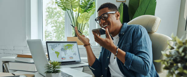 istock Handsome mixed race man talking on phone and smiling 1403852556