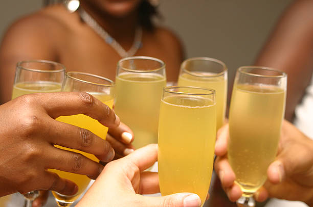 Toast to love a toast amongst friends mimosa stock pictures, royalty-free photos & images