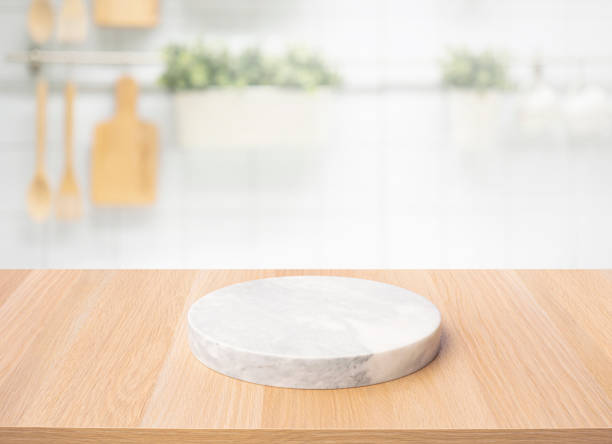 istock Selective focus.Wood table top with chopping board with blur kitchen counter background. 1403855030