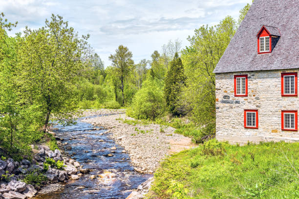 Stone cottage colorful house by river on Chemin du Roy in Quebec, Canada Stone cottage colorful house by river on Chemin du Roy in Quebec, Canada chemin des dames stock pictures, royalty-free photos & images