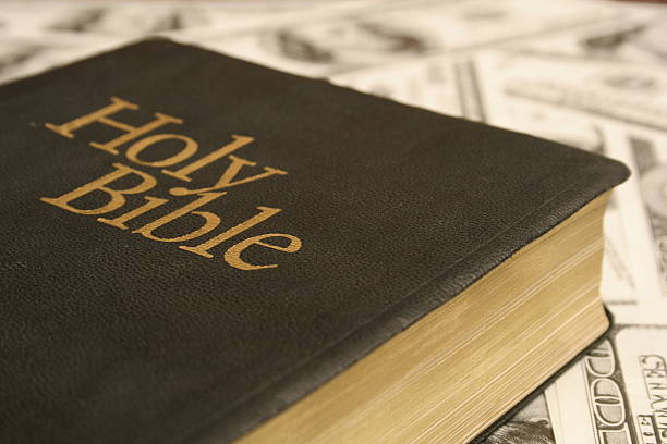 istock Holy Bible on money background 140385666