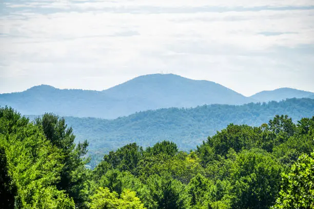 View along road in Afton, Nelson County in Virginia near the Blue Ridge parkway with appalachian mountains in summer, scenic lush foliage landscape and ridges silhouette