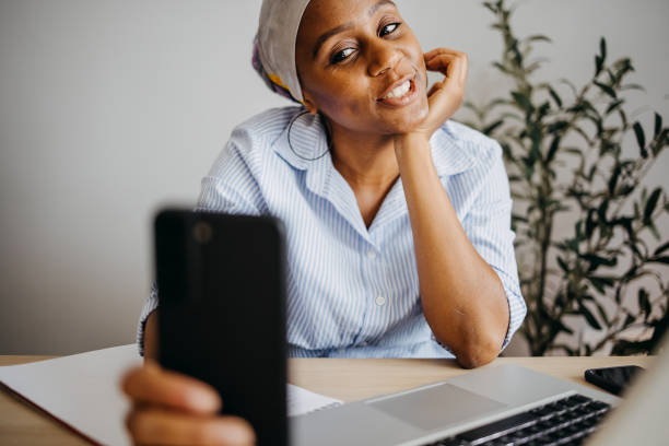 istock Young woman using smart phone at home office 1403857116
