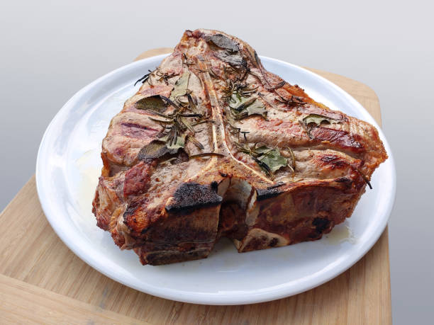 istock White round plate with Whole grilled Fiorentina T-bone steak beef 1403858127