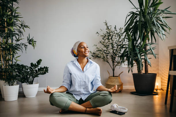 The woman relaxes Woman is sitting on the floor doing yoga, relaxing meditation room office stock pictures, royalty-free photos & images