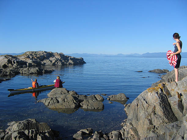 Juan De Fuca Strait - July 10th, 2020: Boats fishing for salmon by trolling along the rocky shores near the kelp beds off of Sooke in the juan de fuca strait on the southern tip of Vancouver Island.