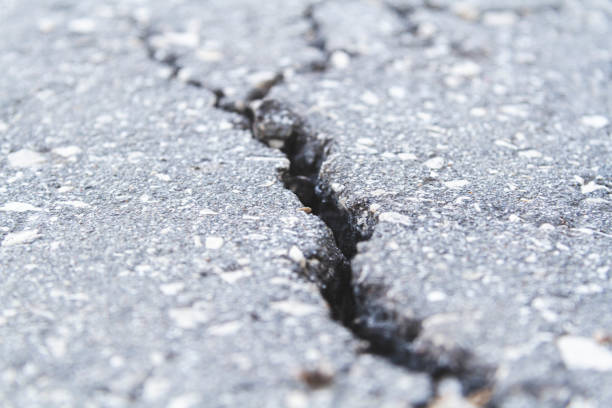 istock Stone wall with deep cracks. Break in the ground. Drought and consequences. 1403861977