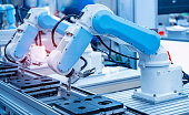 Automatic industrial robotic robot working, industry 4.0 and technology concept
