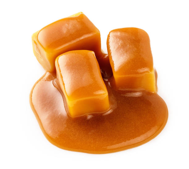 istock Caramel cubes with caramel sauce isolated on white background. 1403862381