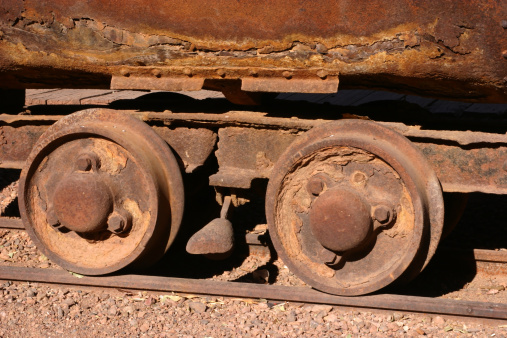 Rusting wheels on an antique mining car on rails in Tombstone Arizona