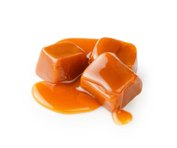 istock Caramel cubes with caramel sauce isolated on white background. 1403862598