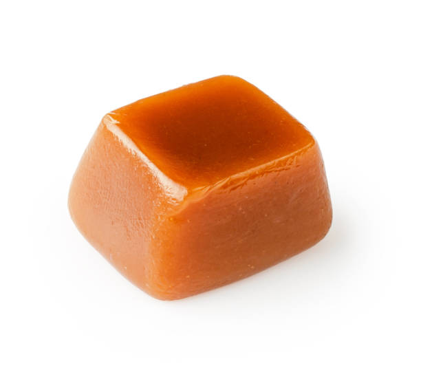 istock Caramel cubes isolated on white background. 1403862706