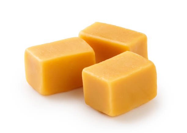 istock Caramel cubes with isolated on white background. 1403863332