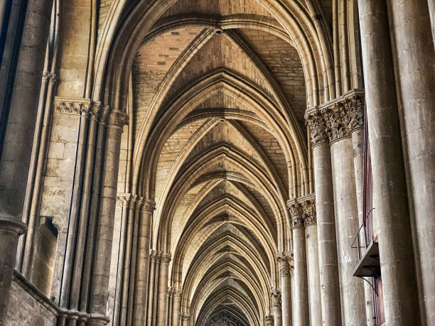 The arched ceilings and towering pillars rise above the nave of the historic landmark Gothic cathderal of Reims.