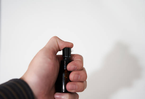 istock finger of hand presses cosmetic perfume bottle 1403863825