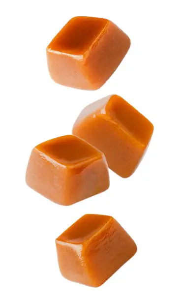 Flying caramel cubes isolated on white background. Set of caramel candies.