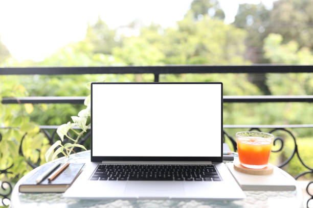 istock laptop white screen on glass table with berry juice 1403864975