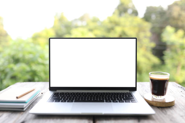 istock Laptop with white screen and coffee glass cup with crema 1403865040