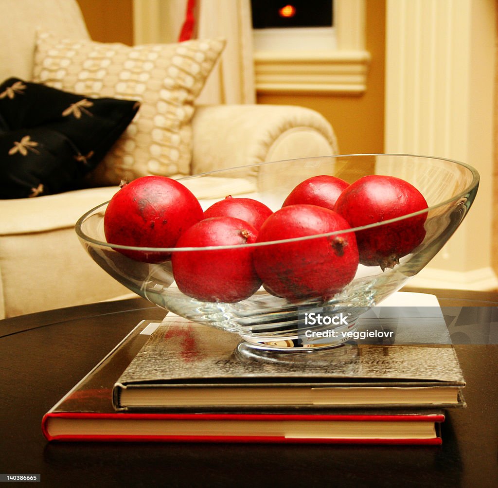 red fruit in glass bowl Close up of pomegranates in glass bowl.  Home interior - red, black and white. Living Room Stock Photo