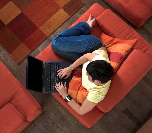 istock View from above of young man, using laptop, seated on chair 140386965