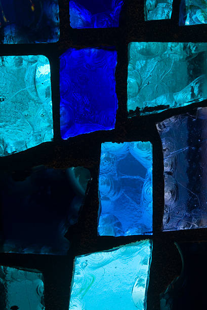 Different shades of blue in stained glass panels stock photo